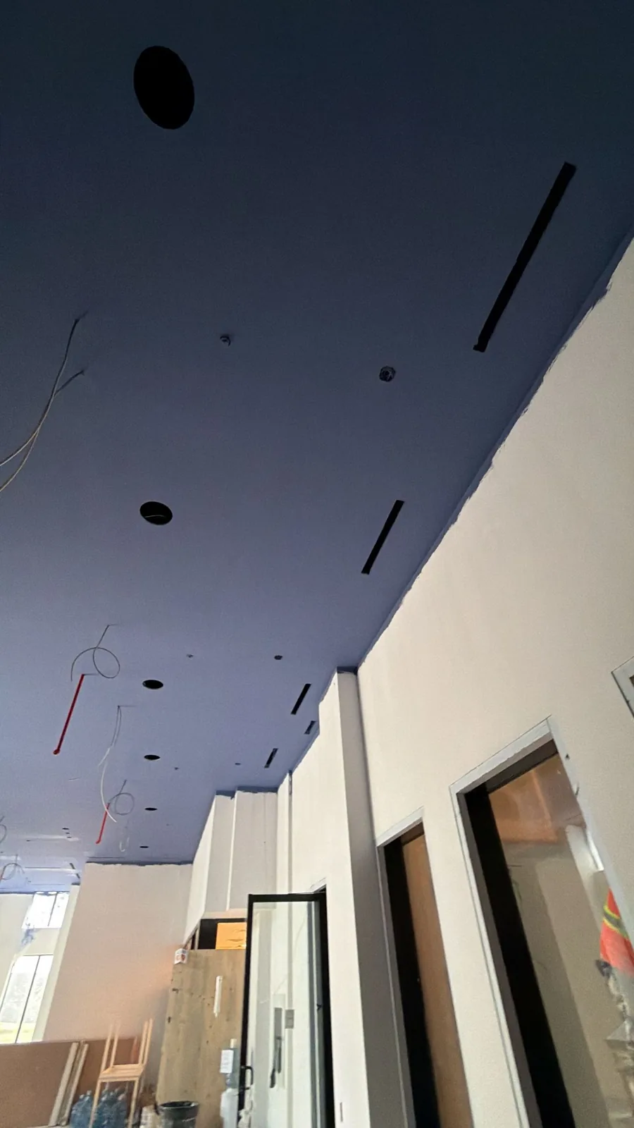 Crisp cut line where the navy ceiling meets the white wall