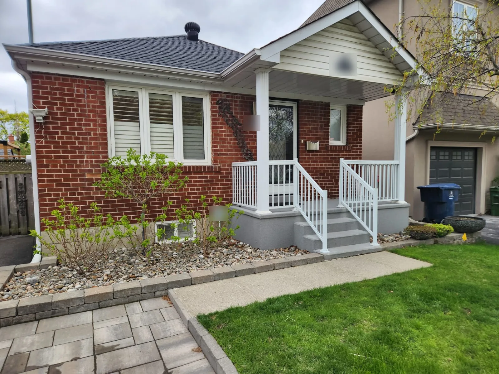 Before: the bungalow with red brick, white windows, white railings and white gutters