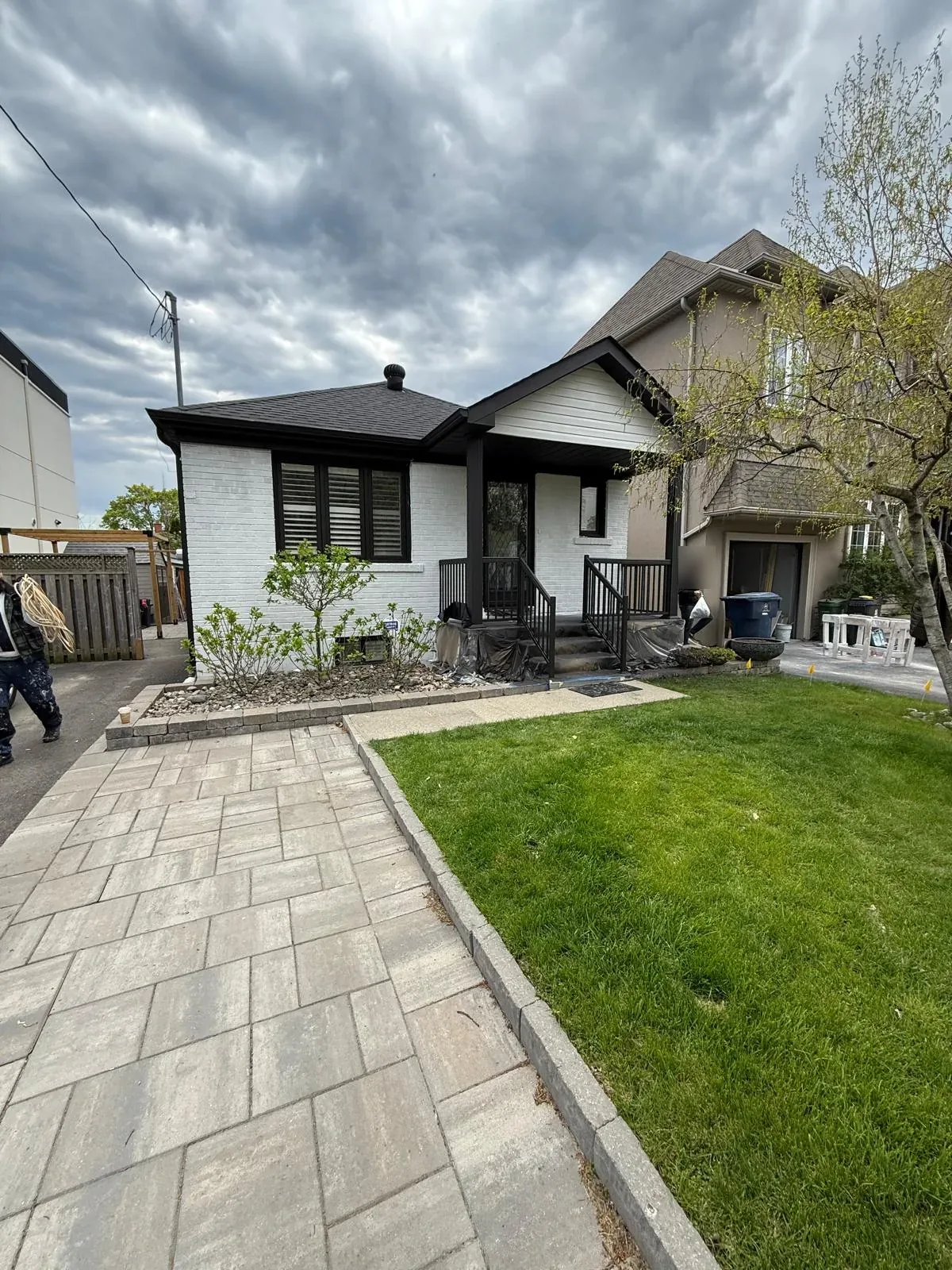 After: the front of the repainted house seen from the side walkway