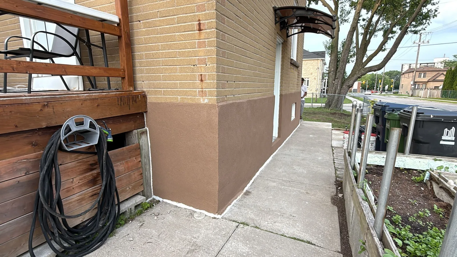 Home foundation refinished in tinted stucco colour-matched to the brick — FAIME exterior foundation project