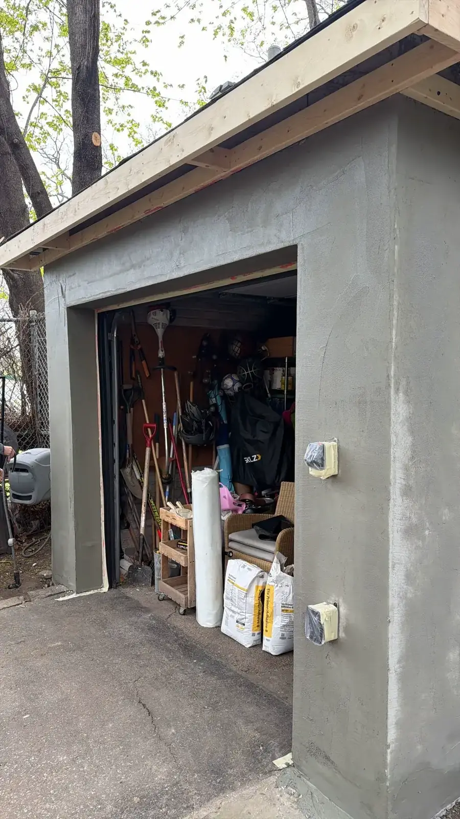 Base coat applied at the garage front corner and door opening