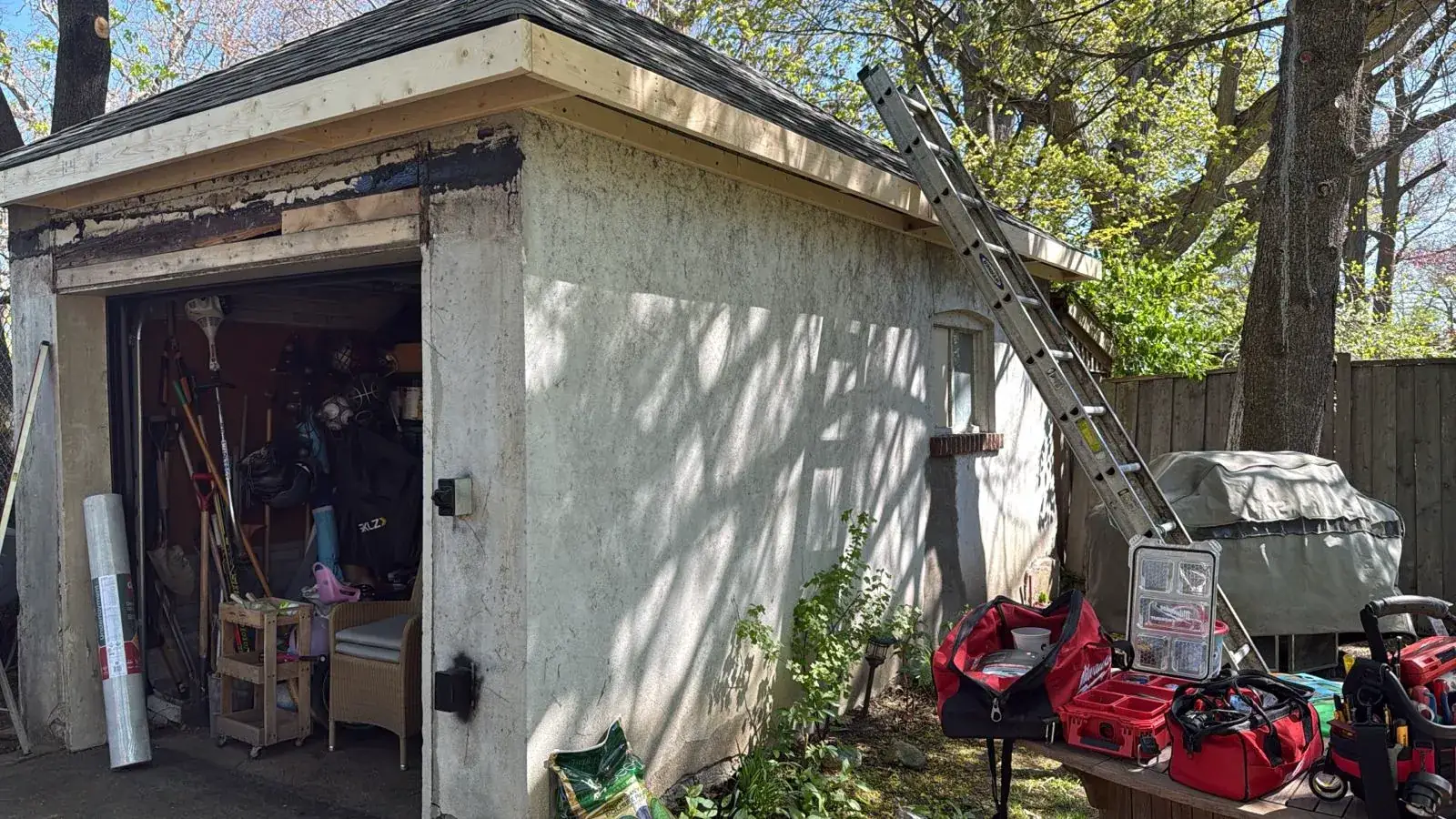 Weathered garage stucco and fascia rebuilt with new lumber