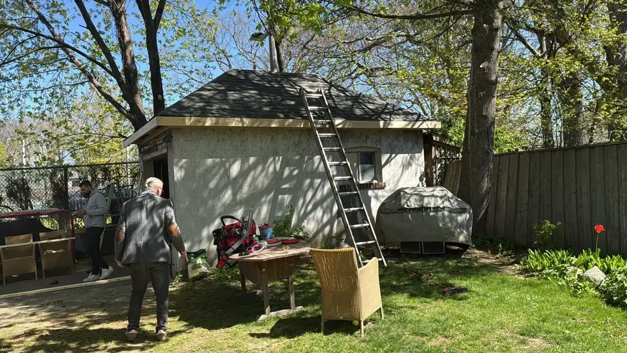 Backyard detached garage before refinishing, with weathered stucco