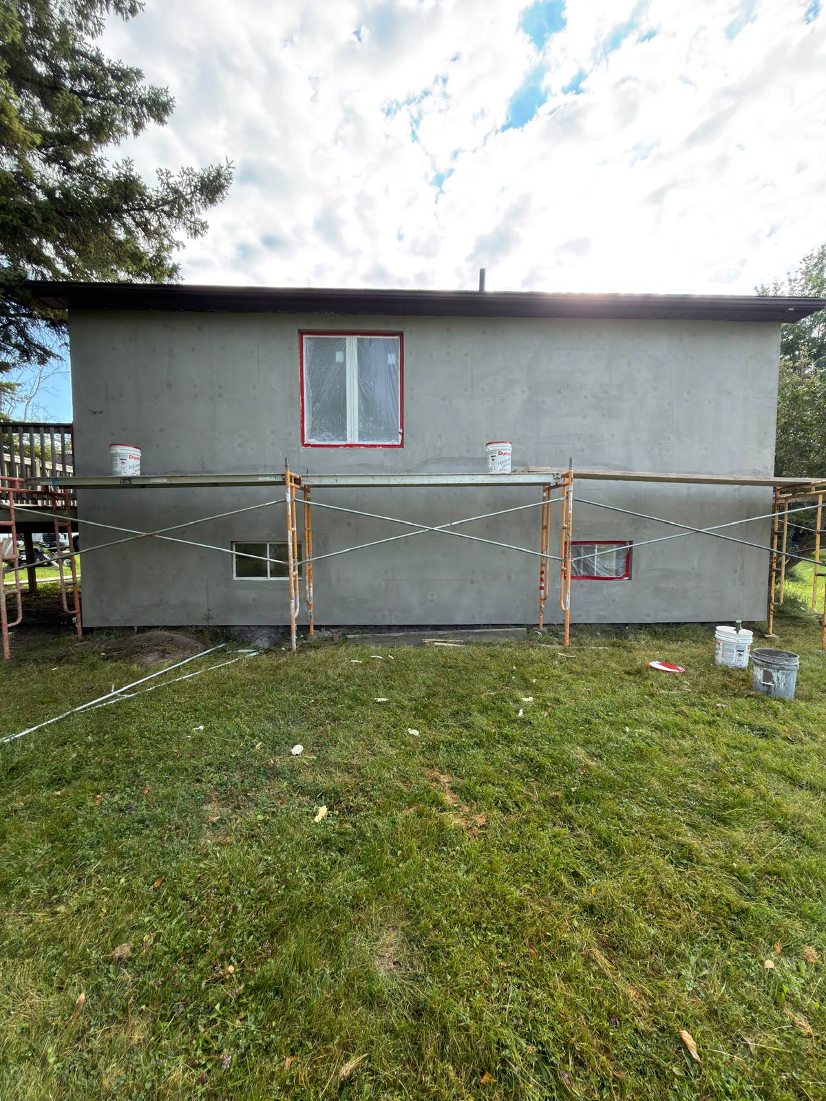 Rear elevation of the bungalow wrapped in base coat and levelled ready for the finish