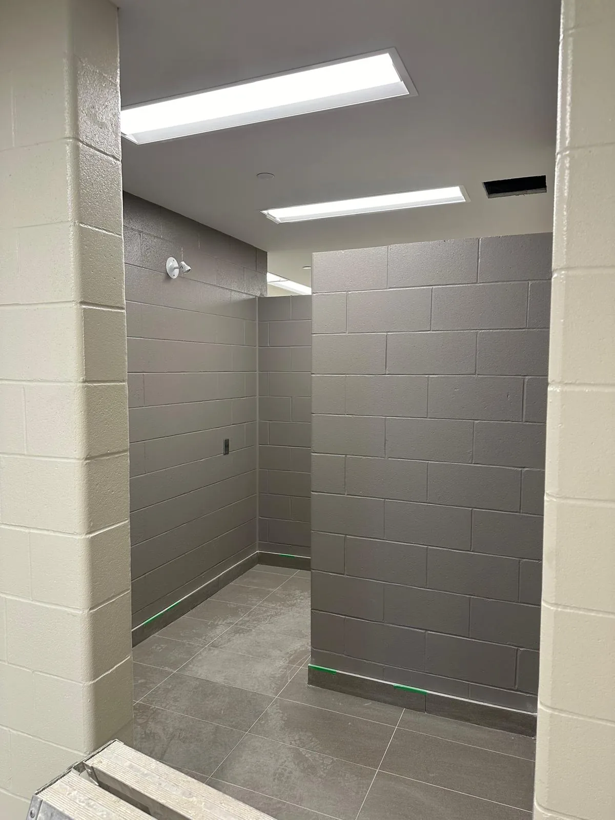 A change area with painted block walls in grey and white