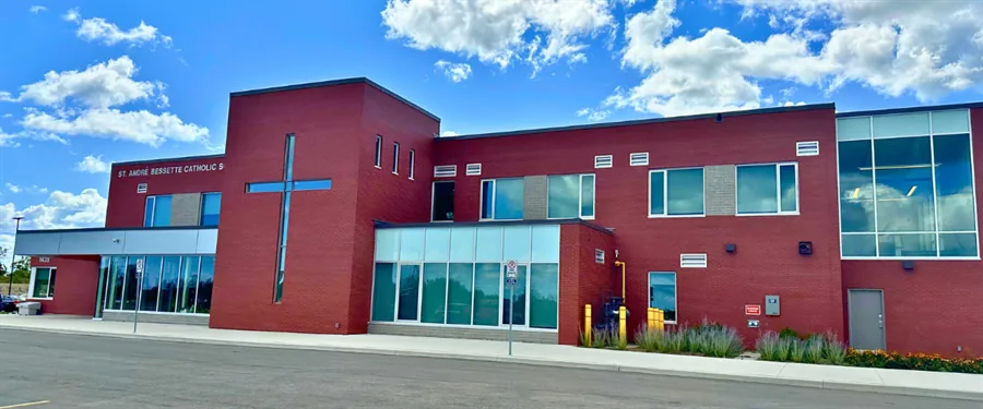 The red-brick exterior of St. André Bessette Catholic School in Innisfil, with its tall cross window