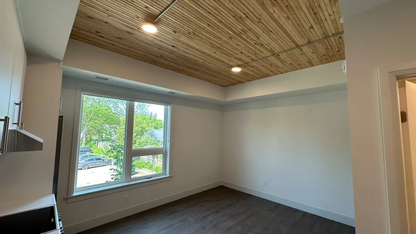 A finished suite in the KW Habilitation affordable housing building, with painted walls beneath an exposed timber ceiling