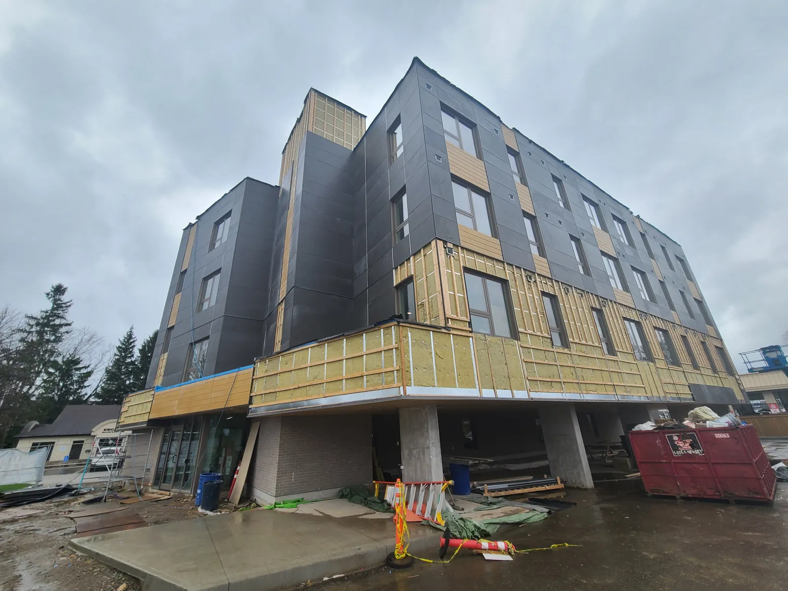 The building during construction, with exterior insulation and siding being installed