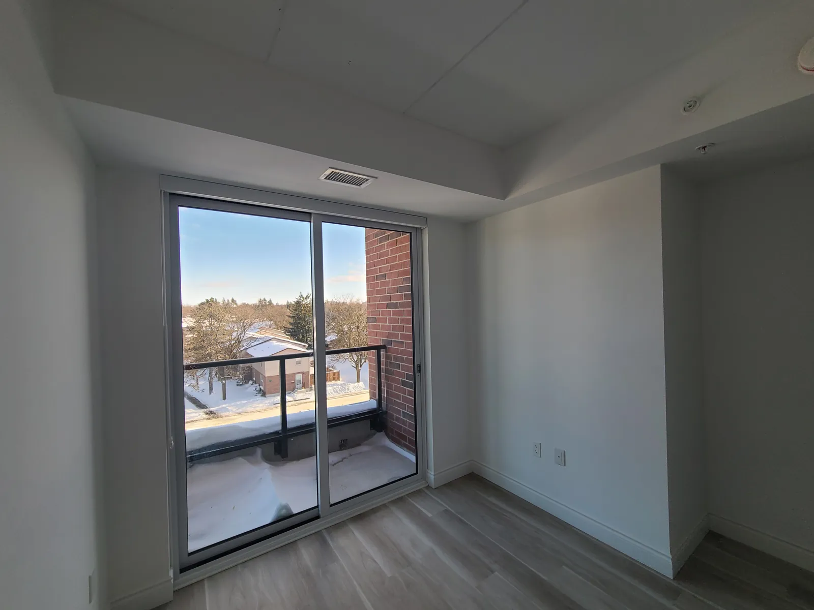 A suite room with painted walls and ceiling and a sliding door onto the balcony