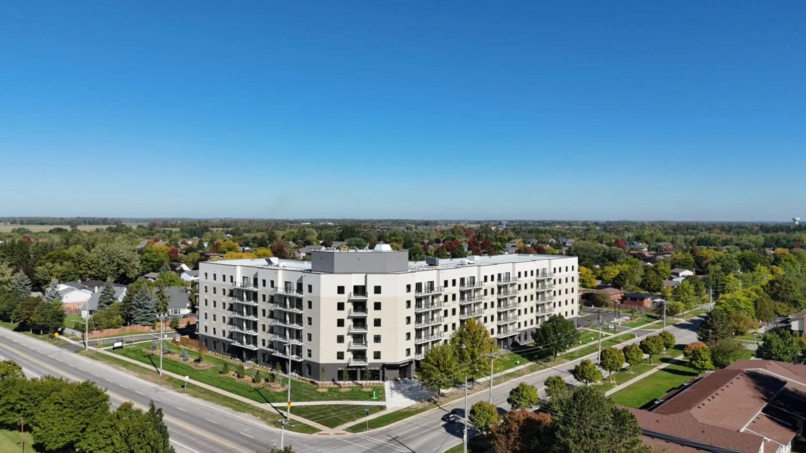Aerial view of the completed Queensland Condos building and its landscaped grounds in Stratford