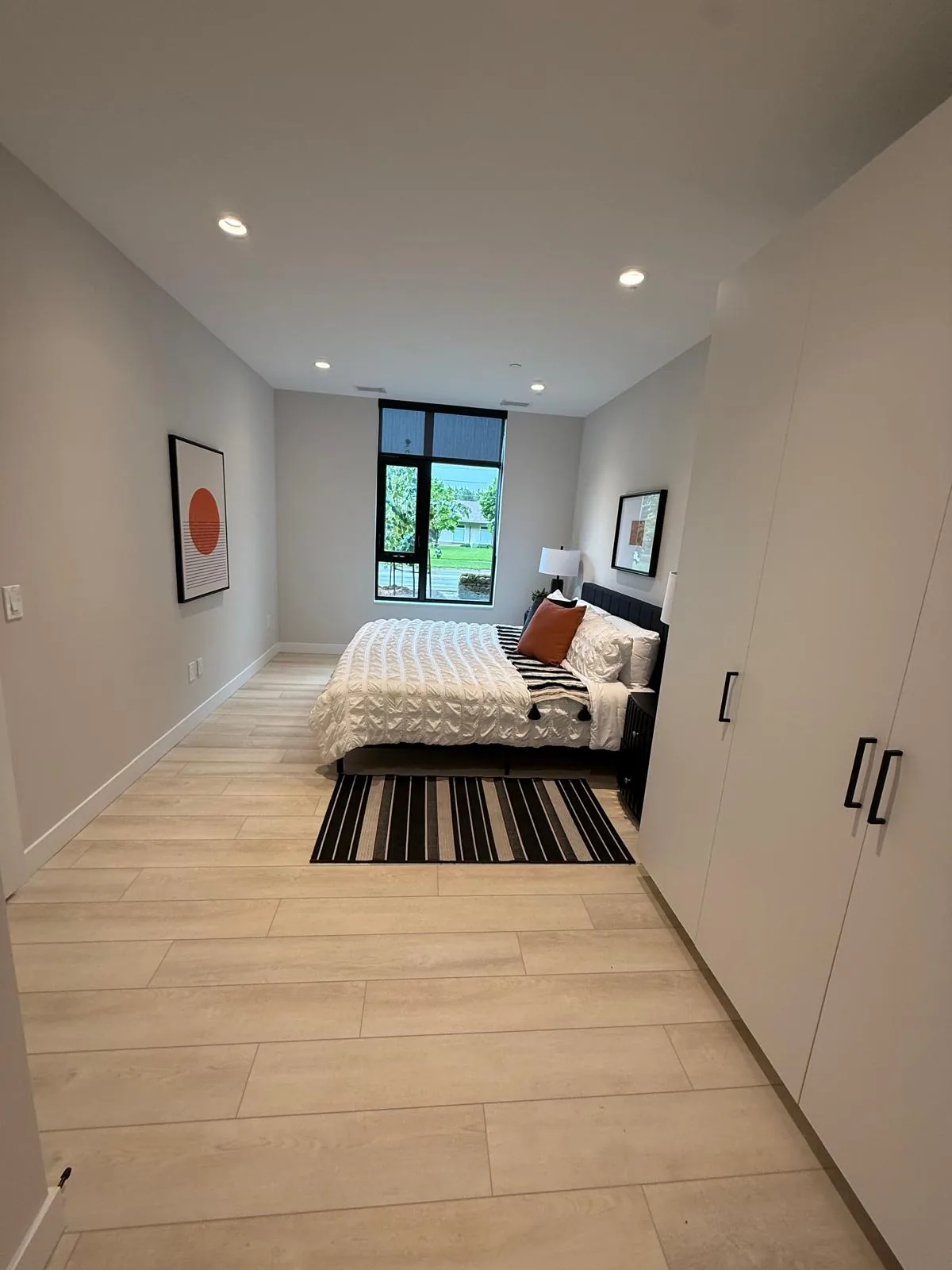 A suite bedroom with finished walls, ceiling, baseboards and closet doors