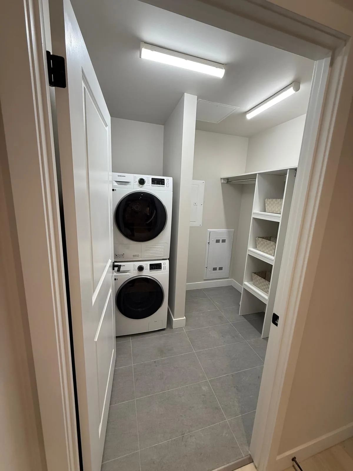 A suite laundry and storage room with painted walls, door and jamb