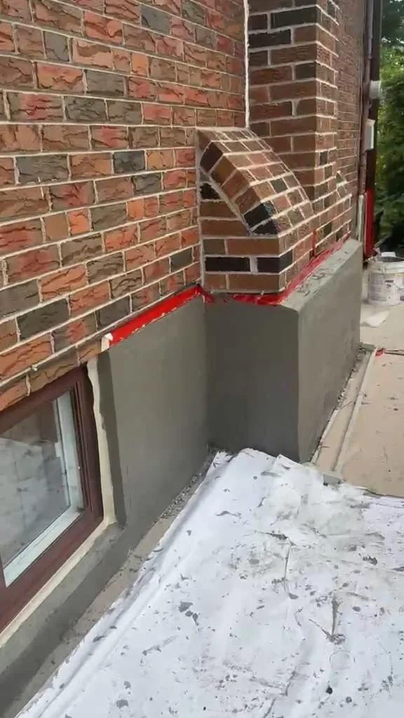 Base coat wrapped around the corner and brick chimney return