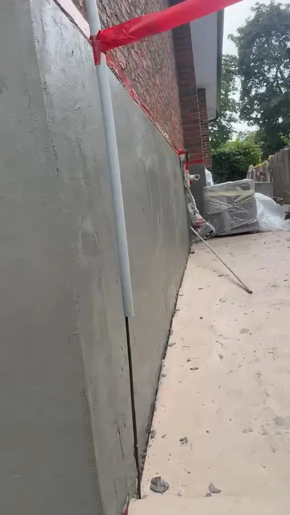 Long wall in fresh base coat with mesh embedded and covered