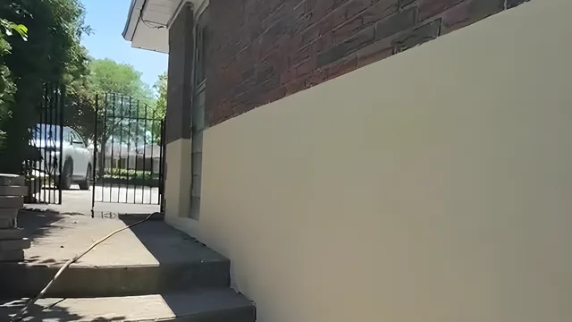 Finished exterior stucco in a warm tinted finish along the side steps — Scarborough stucco refinishing