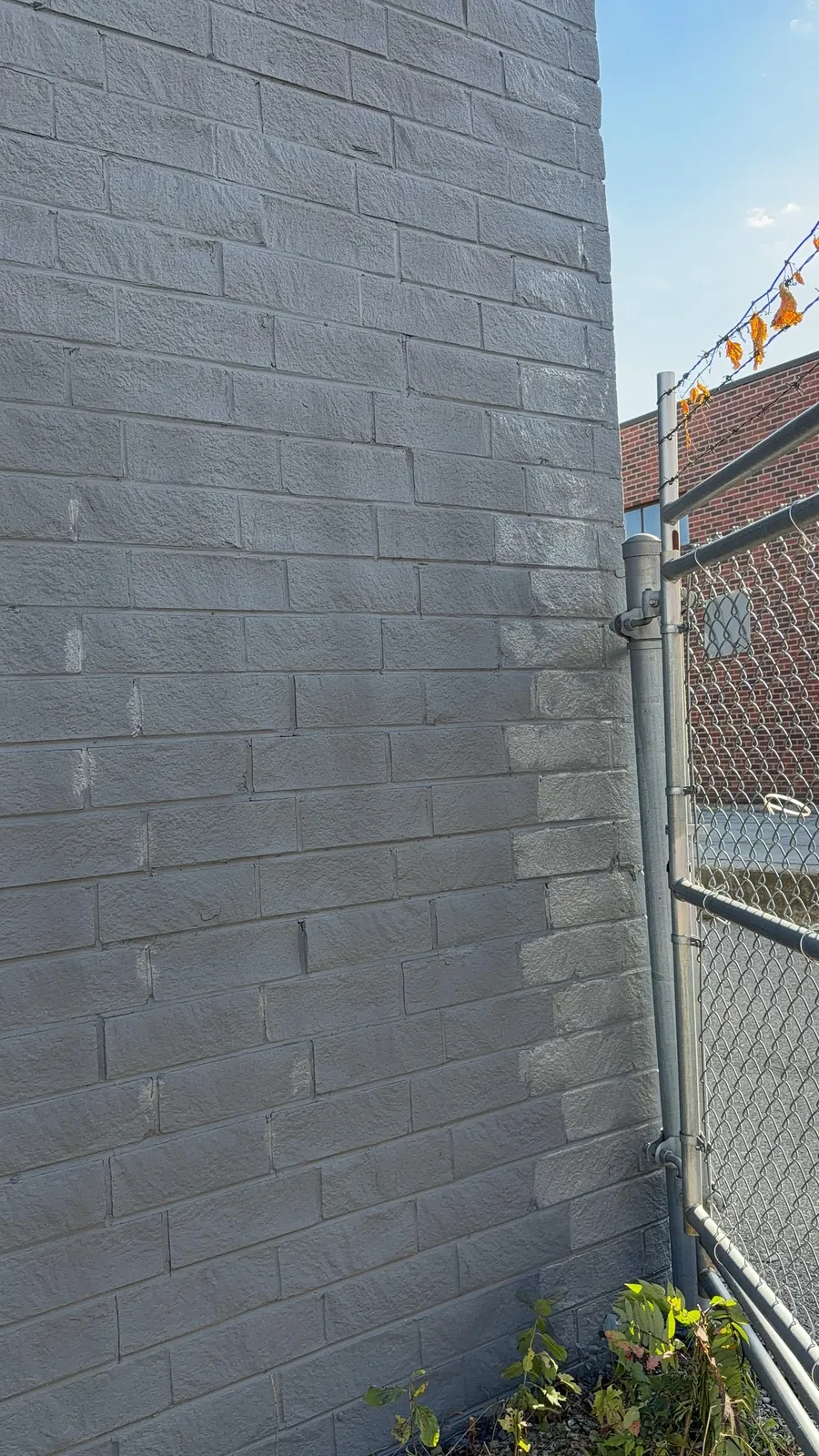 A brick wall section painted in the new grey, every joint covered