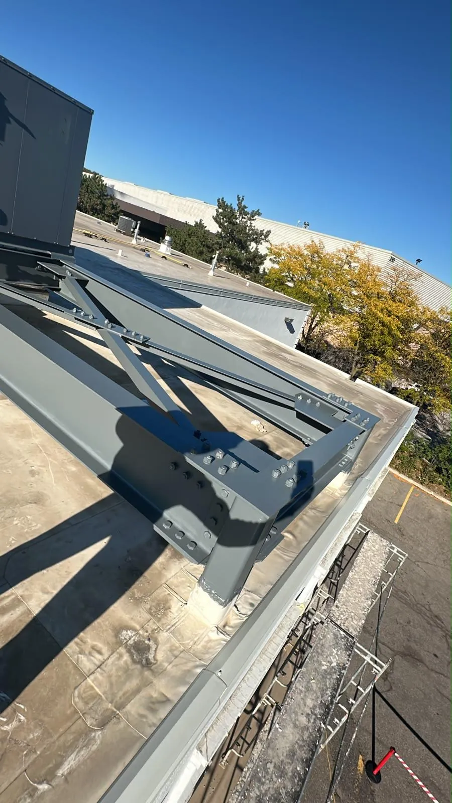 Roof-level metal framing freshly painted in grey