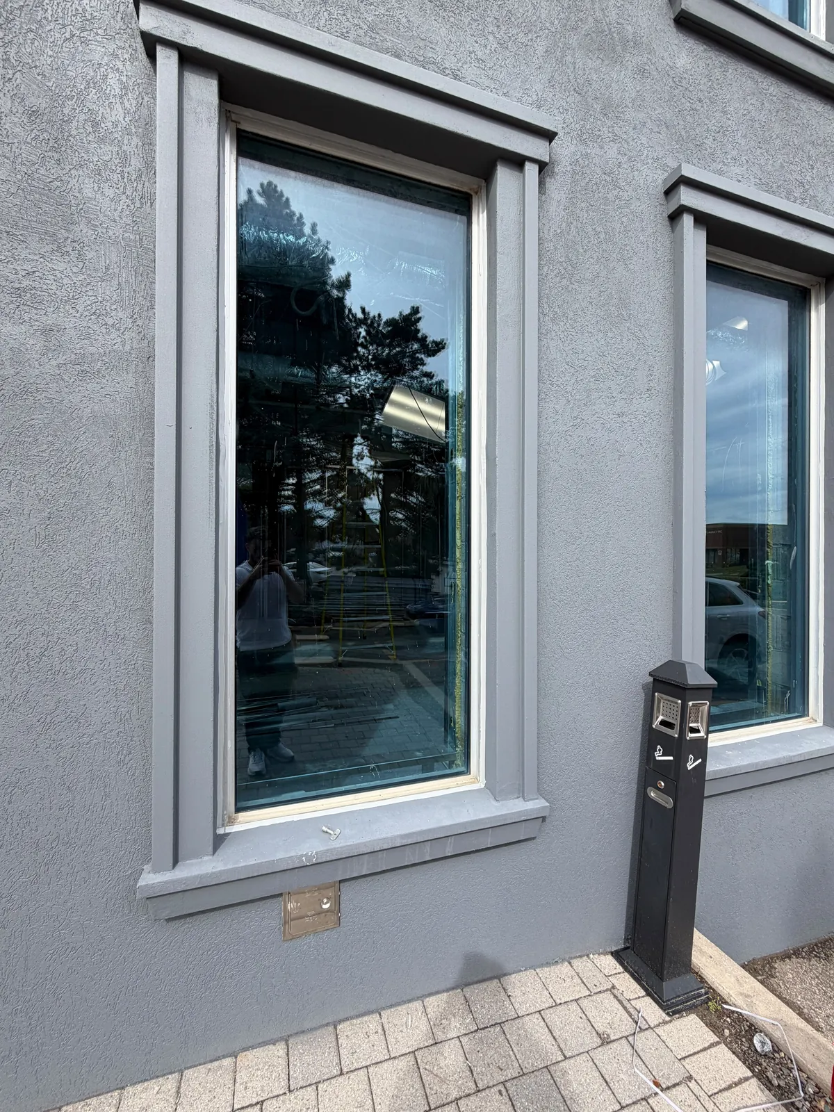 A finished window surround and sill on the dark grey wall