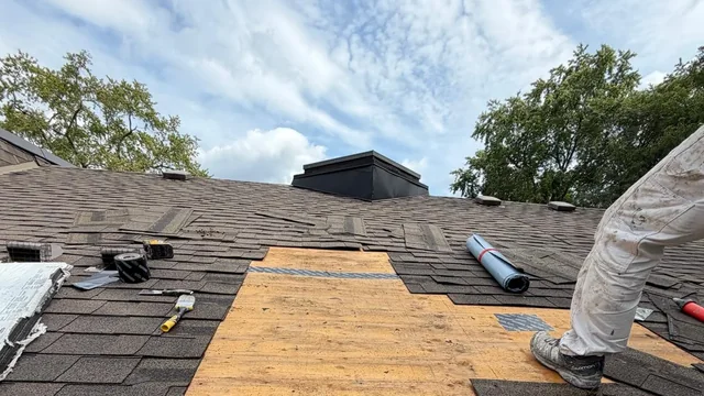 A Willowdale roof opened up during a leak repair, shingles cut back around a new plywood deck section