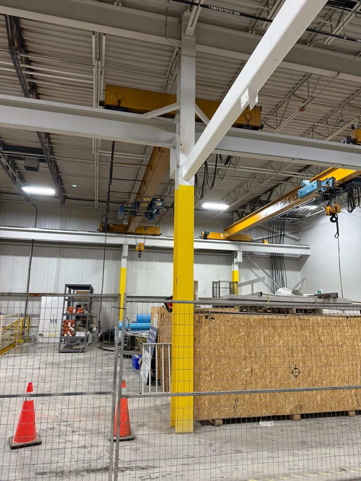 A coated column and overhead beams beneath the warehouse roof