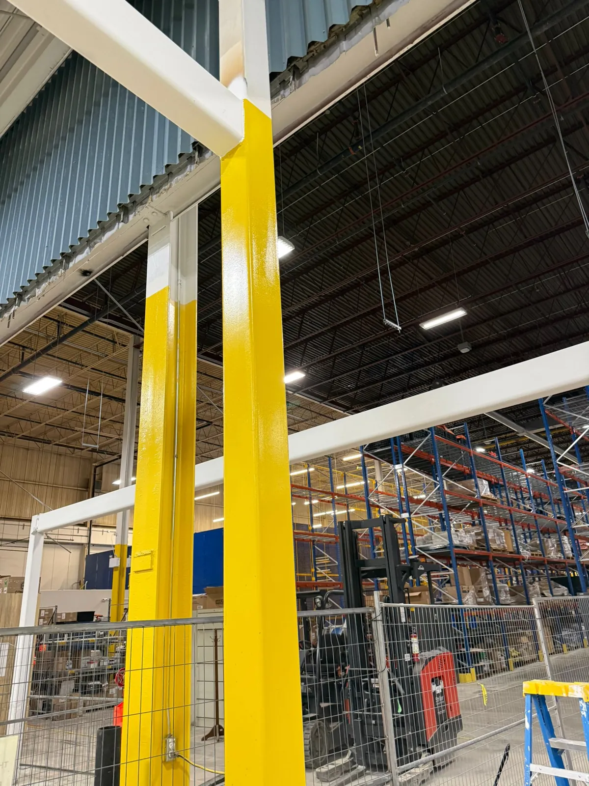 Close view of coated beams meeting a column