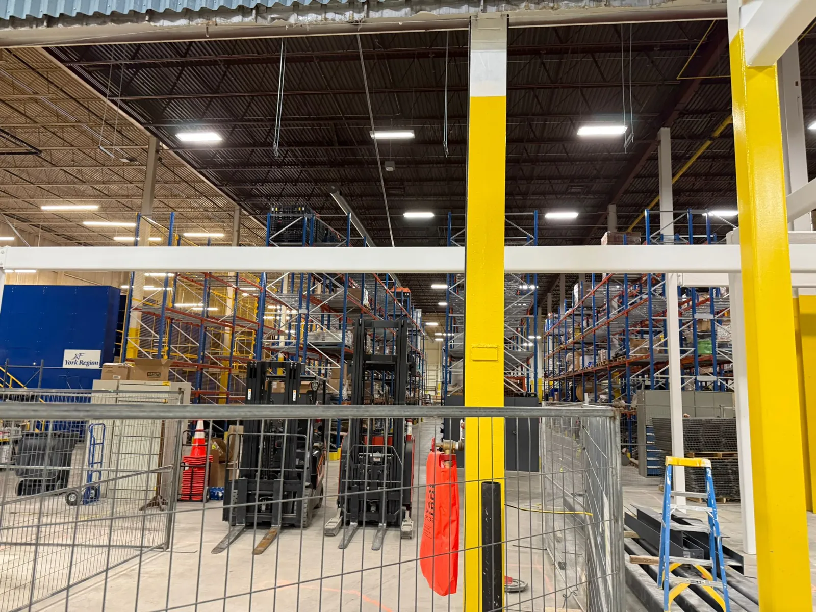 Coated columns and beams alongside an active warehouse aisle