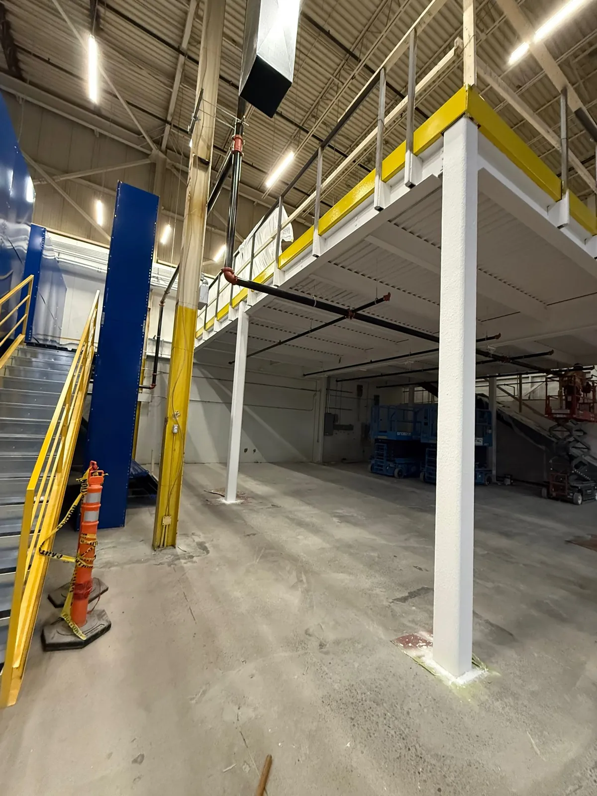 The coated steel deck underside and supporting column of the mezzanine
