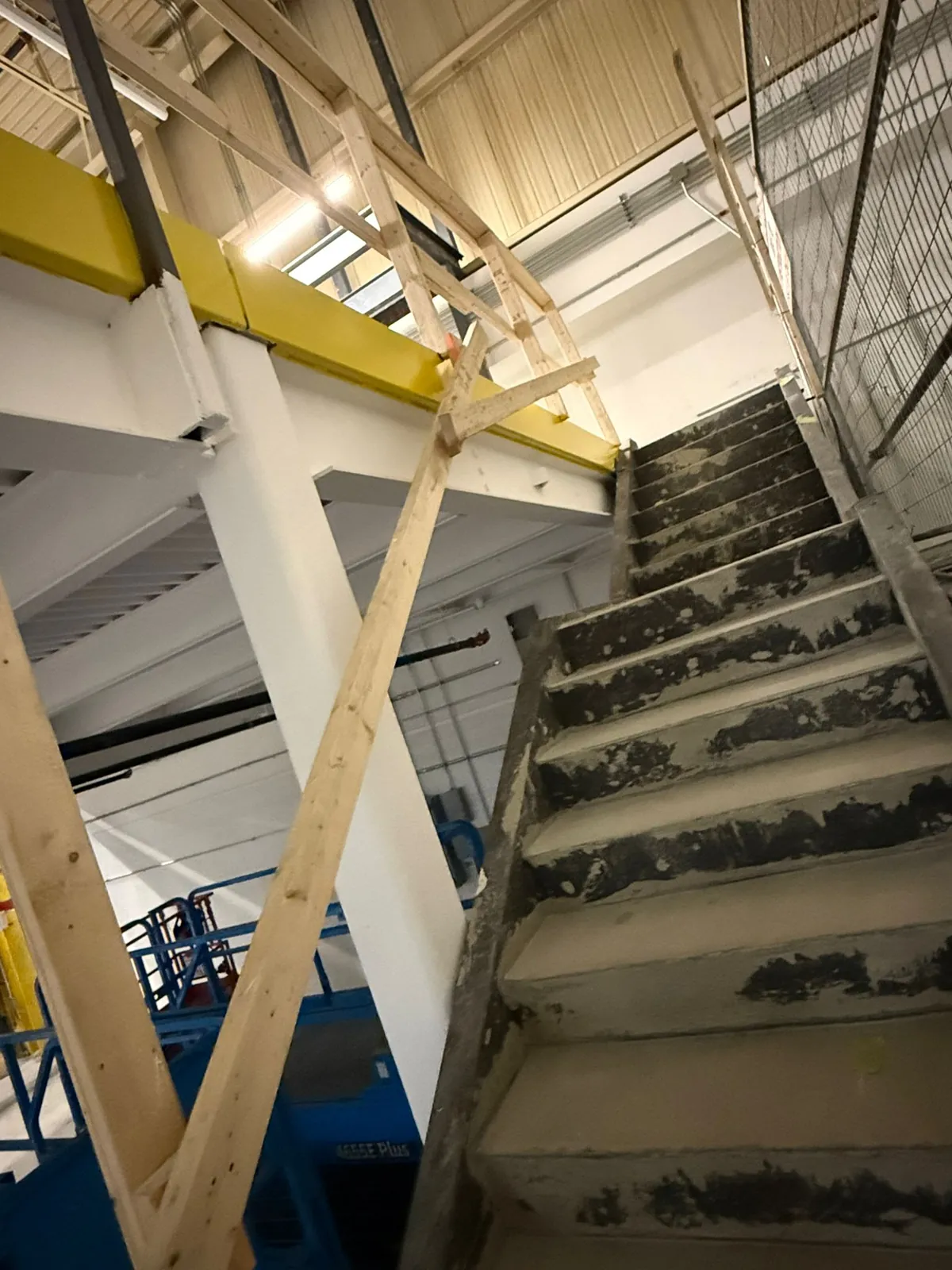 The underside of the coated mezzanine next to its access stair